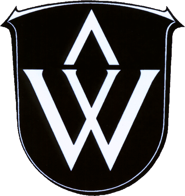 Das Wickerer Wappen nimmt den ersten Buchstaben des Ortsnamens auf. Darüber steht ein Sparren, der an die Herrschaft der Eppsteiner Grafen über Wicker erinnert.