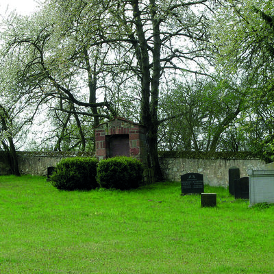 Gedenkstein und Gräber auf dem jüdischen Friedhof